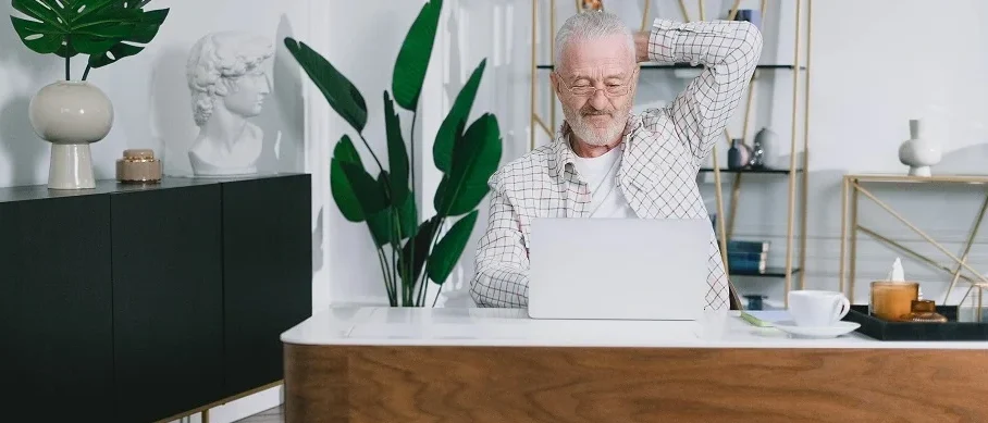 Guesthouse owner analysing booking statistics on a laptop.