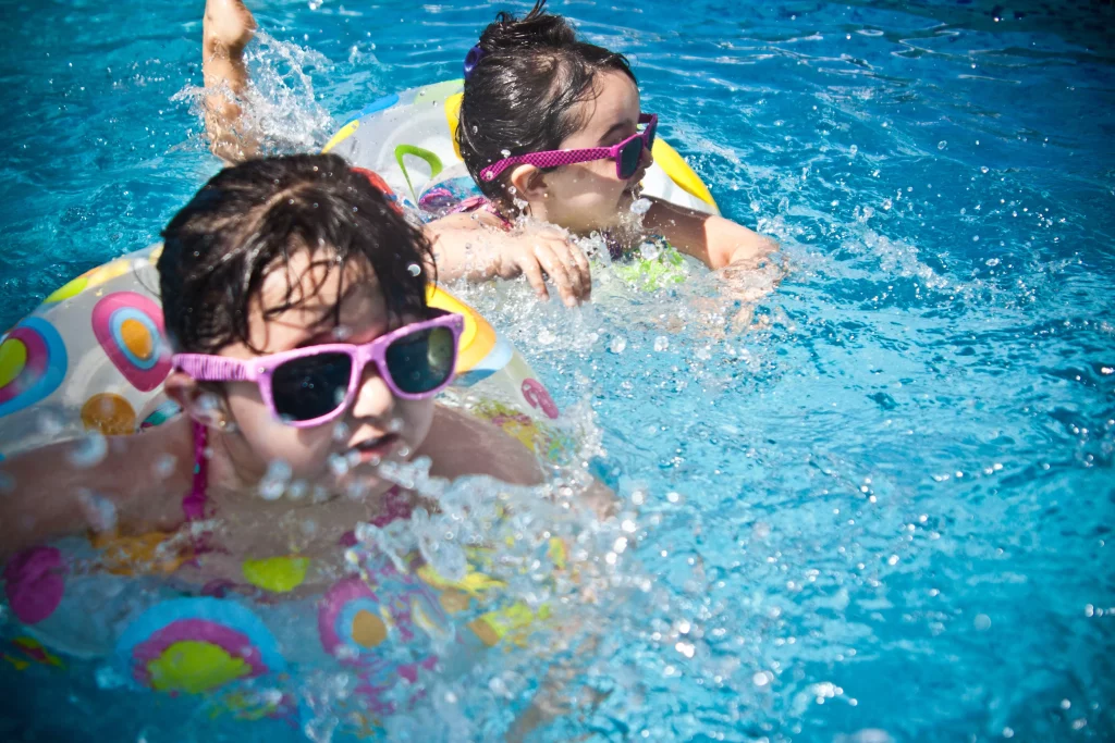 Children playing in the pool at a facility with attractions for families with children.